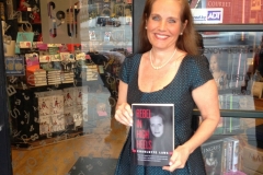 Charlotte Laws with her first memoir, Rebel in High Heels